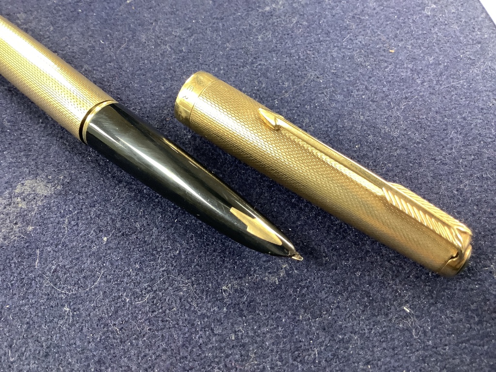 Five assorted pens to include a 9ct gold Parker